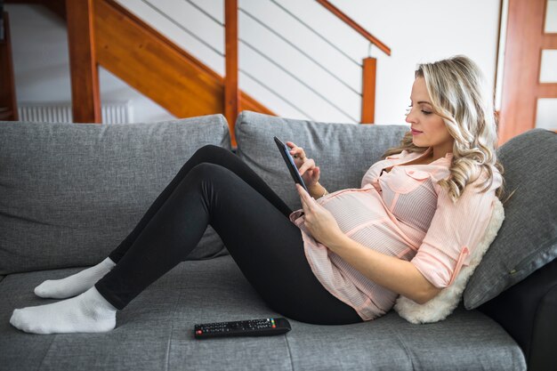 side-view-beautiful-pregnant-woman-lying-bed-using-digital-tablet_23-2147837506.jpg