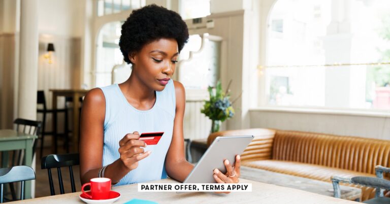 SOCIAL-IMAGE_PARTNER-OFFERS-TERMS-APPLY_Person-holding-credit-card-while-using-tablet-at-cafe_Tim-Ro.jpeg