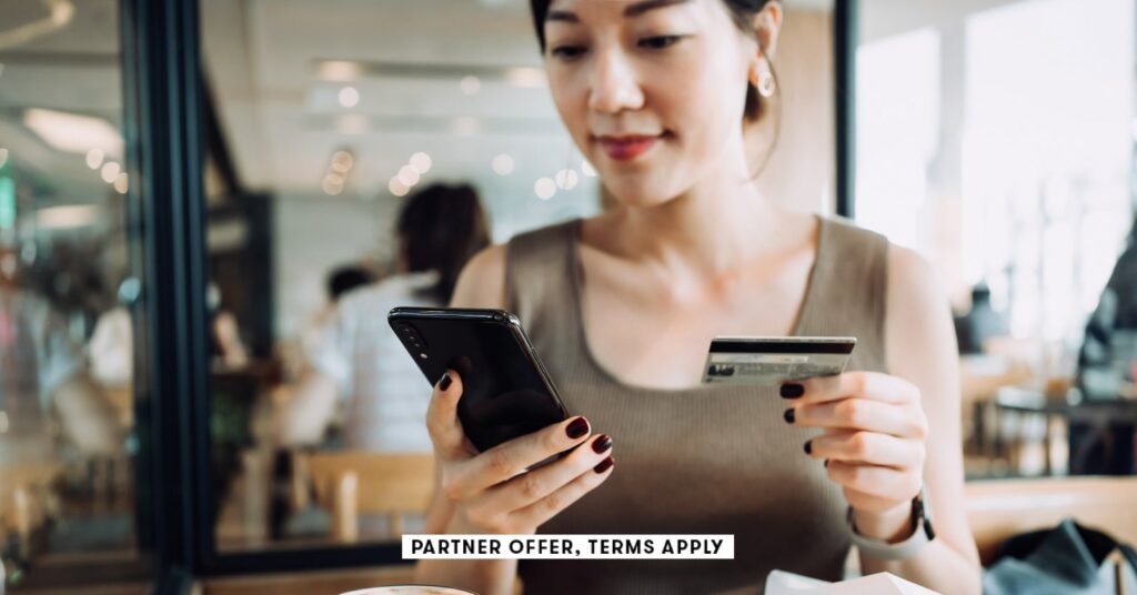 SOCIAL-IMAGE_PARTNER-OFFERS-TERMS-APPLY_woman-managing-online-banking-with-smartphone-and-making-mob.jpeg