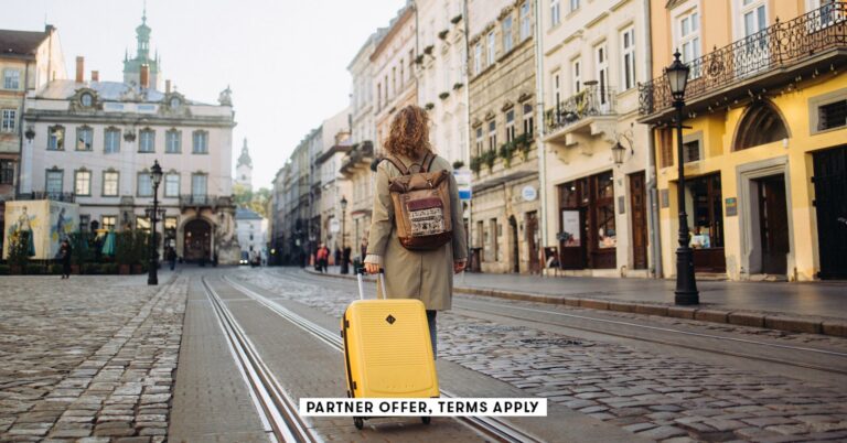 SOCIAL-IMAGE_PARTNER-OFFER-TERMS-APPLY_woman-with-a-suitcase-walking-on-European-street_Nazar-Rybak.jpeg