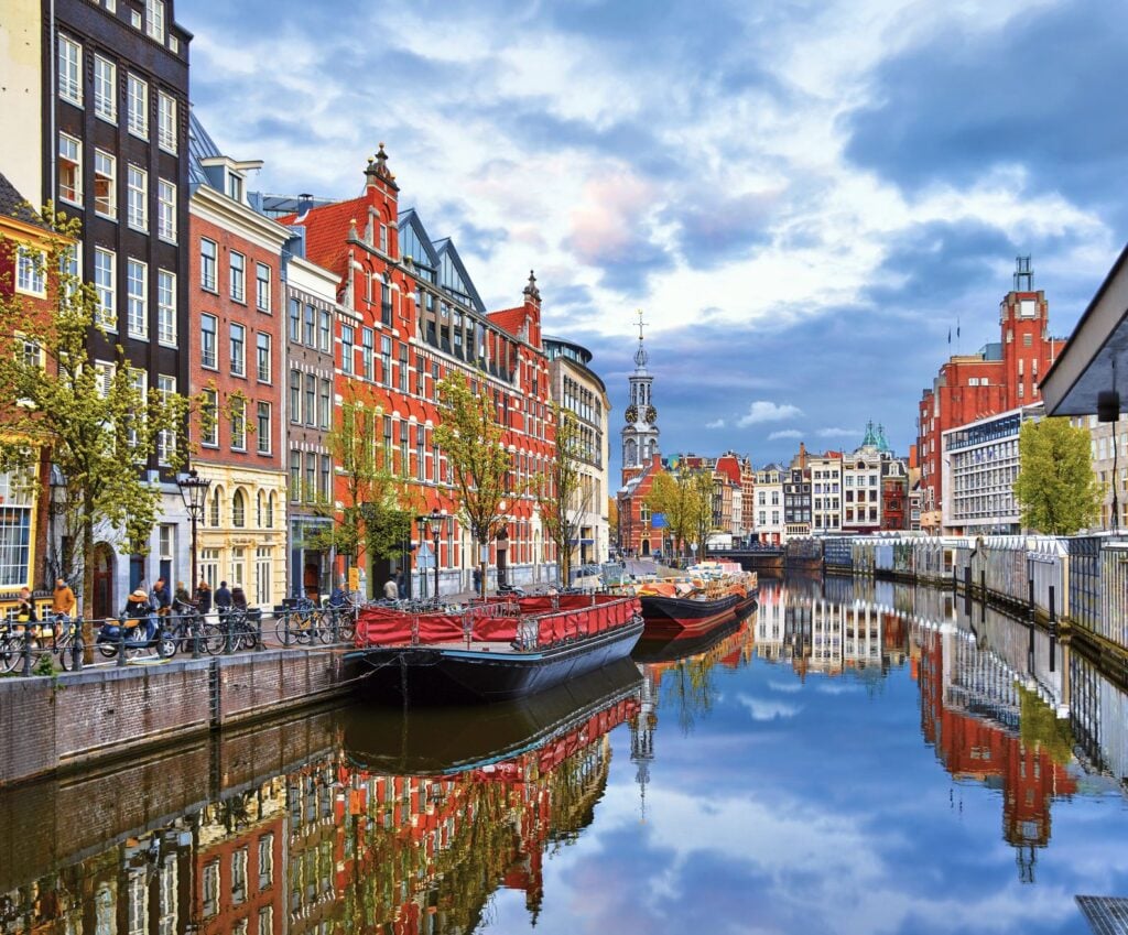 The-canal-in-Amsterdam-Netherlands-houses-the-Amstel-River-which-is-the-landmark-of-the-ancient-Euro.jpeg