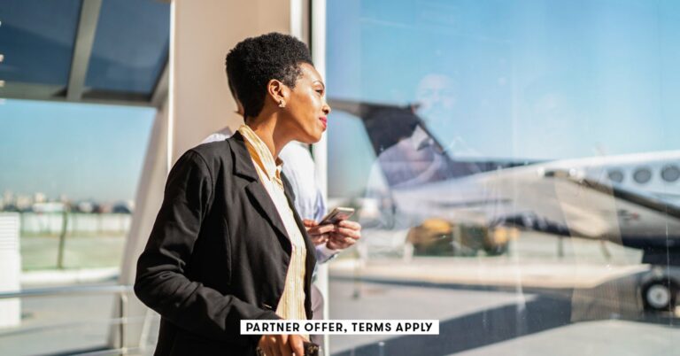 SOCIAL-IMAGE_PARTNER-OFFER-TERMS-APPLY_ooking-through-the-window-and-using-smartphone-in-the-airport.jpeg