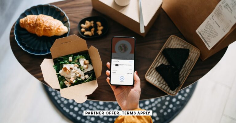 SOCIAL-IMAGE_PARTNER-OFFER-TERMS-APPLY_womans-hand-holding-smartphone-with-takeaway-food-ordering-mo.jpeg
