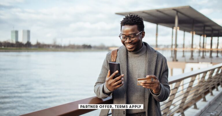 SOCIAL-IMAGE_PARTNER-OFFERS-TERMS-APPLY_businessman-standing-on-street-and-using-smart-phone-and-ban.jpeg