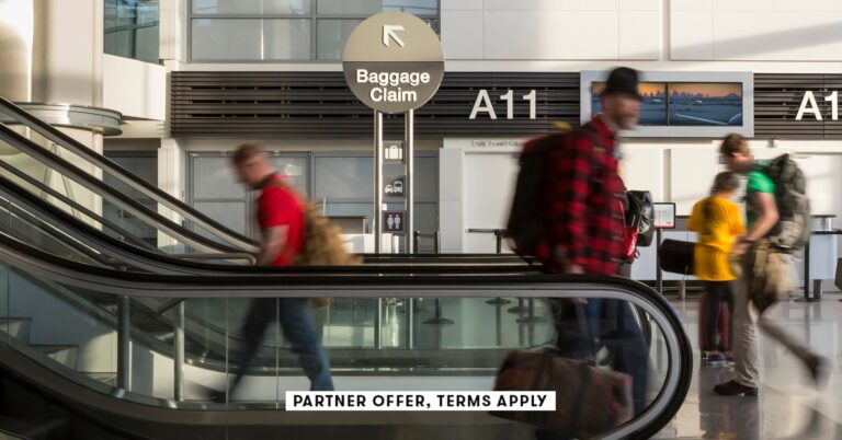 Travelers-at-airport-walking-by-baggage-claim-sign_David-Papazian_SOCIAL.jpg